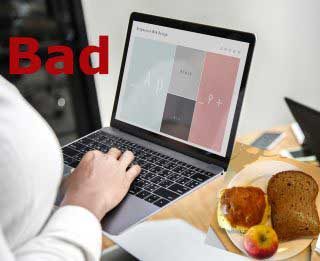 Lady eating while using computer