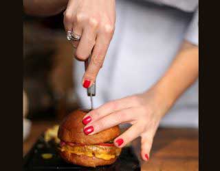 burger cut by women with knife