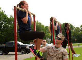 fitness coach checking WomanStrength during military training